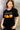 female model wearing black nightshift t-shirt in front of gray background.t